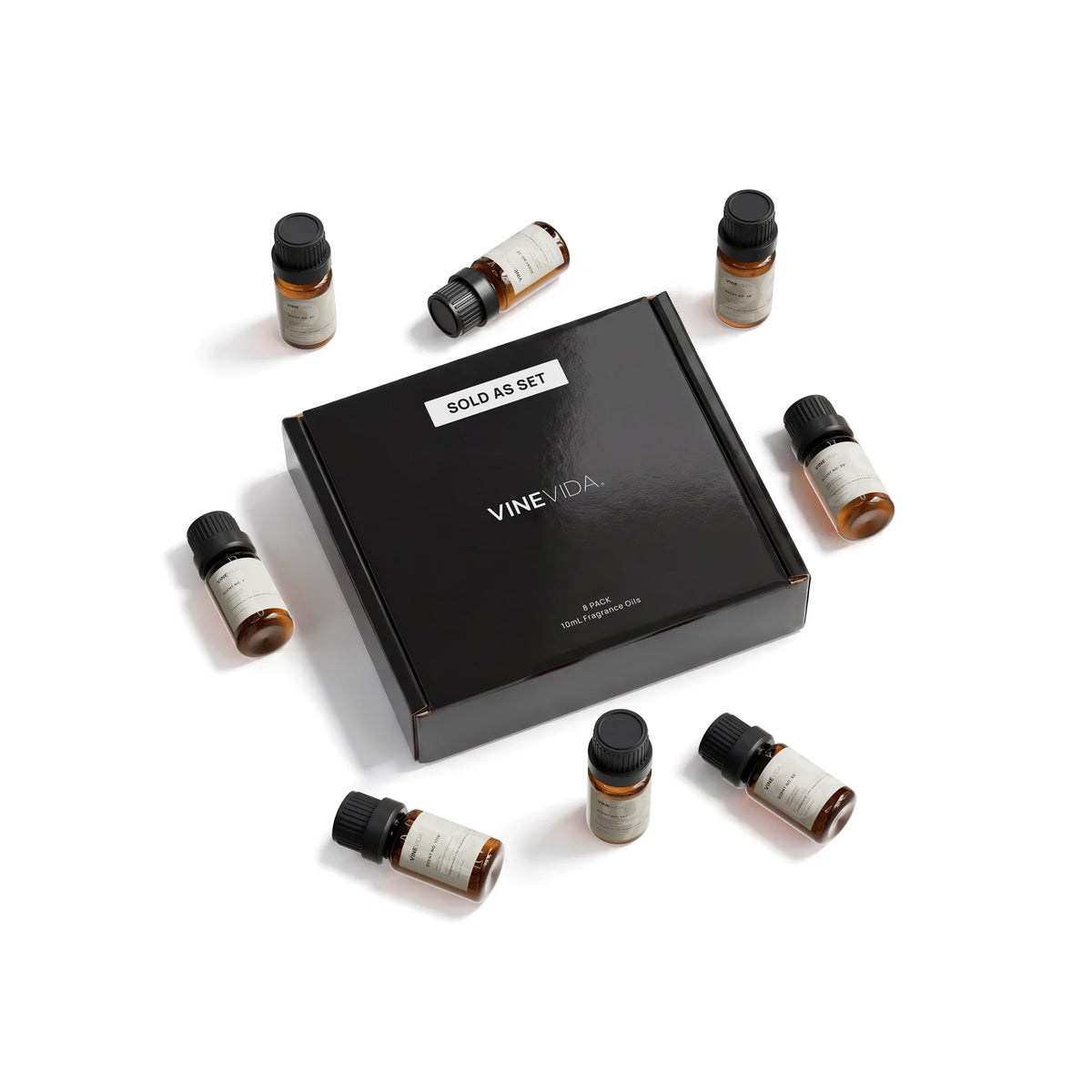 Fall Soap & Candle Fragrance Oil Set - 8 VINEVIDA 10mL amber glass oil bottles arranged around closed black "Sold as Set" gift box, flat lay overhead angle