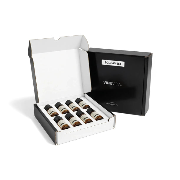 Fall Diffuser Fragrance Oil Set - Black gift box open showing 8 amber glass 10mL oil bottles nestled in white insert, with closed box behind displaying "Sold as Set" label