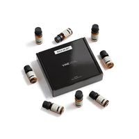 Masculine Diffuser Fragrance Oil Set - 8 VINEVIDA 10mL amber glass oil bottles arranged around closed black "Sold as Set" gift box, flat lay overhead angle